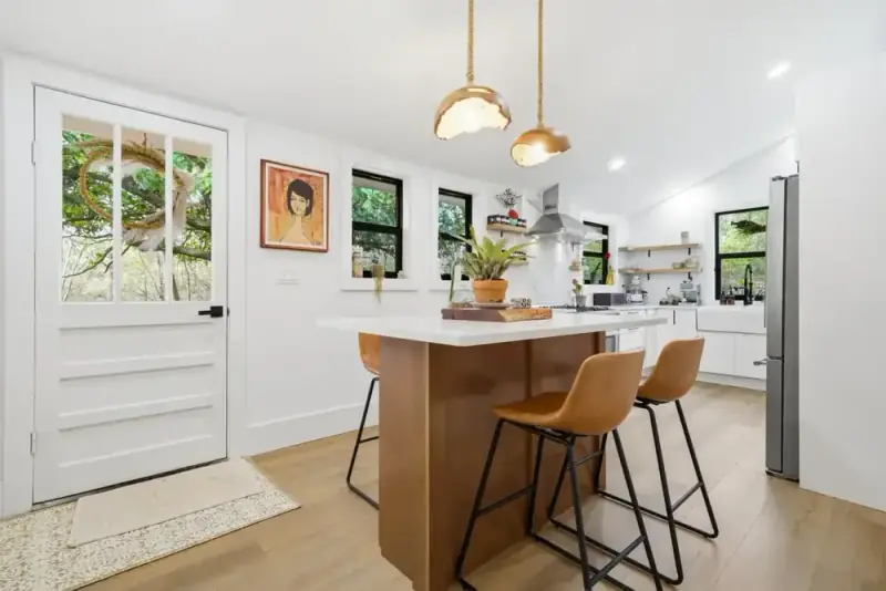Entry and dining area at 356 Hyde Road with a wood table, pendant lights, and framed artwork