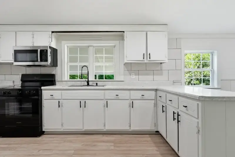 White kitchen with stainless steel appliances at 497 Pack Road